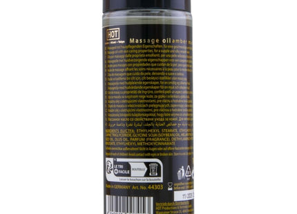 Klar glasflasche mit schwarzem verschluss und etikett mit transparentem massageöl amber und moschus 100 ml