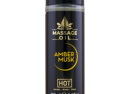 Schwarze glasflasche mit schwarzem deckel und goldener aufschrift massageöl amber musk hot im 100 ml format