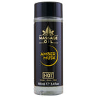 Schwarze glasflasche mit schwarzem deckel und goldener aufschrift massageöl amber musk hot im 100 ml format