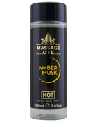 Schwarze glasflasche mit schwarzem deckel und goldener aufschrift massageöl amber musk hot im 100 ml format