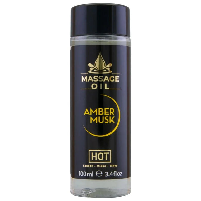 Schwarze glasflasche mit schwarzem deckel und goldener aufschrift massageöl amber musk hot im 100 ml format