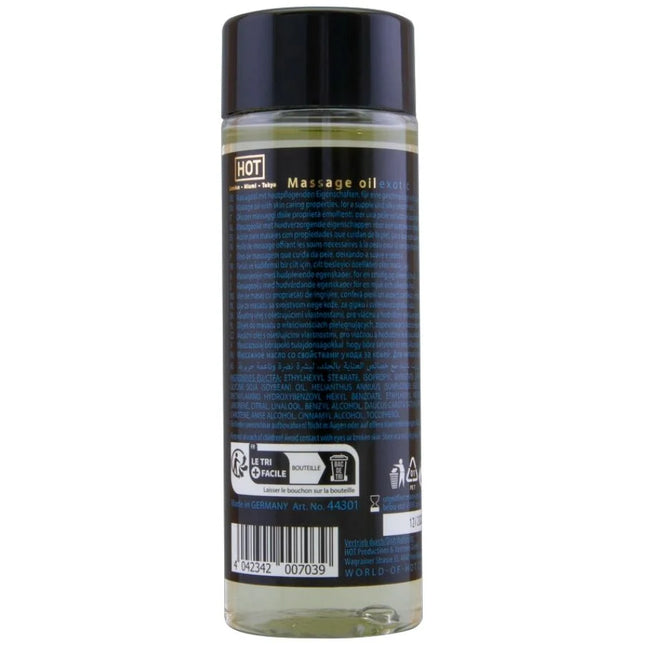Klar glasflasche mit schwarzem verschluss und dunkelblauem etikett mit hellem gelbem massageöl hot massageöl exotisch spezial 100 ml