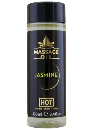 Schwarze glasflasche mit goldener schrift und schwarzem deckel mit massageöl jasmin hot 100 ml fassungsvermögen