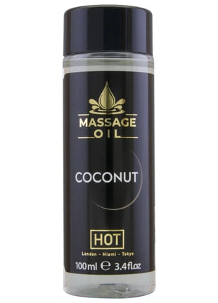 Hot massageöl kokosnuss 100 ml in klarer glasflasche mit schwarzem und goldenem etikett für entspannende massages