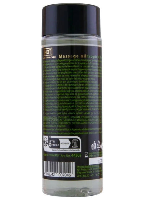 Klare glasflasche mit schwarzem verschluss und etikett enthält tropisches massageöl hot - massageöl tropische früchte 100 ml