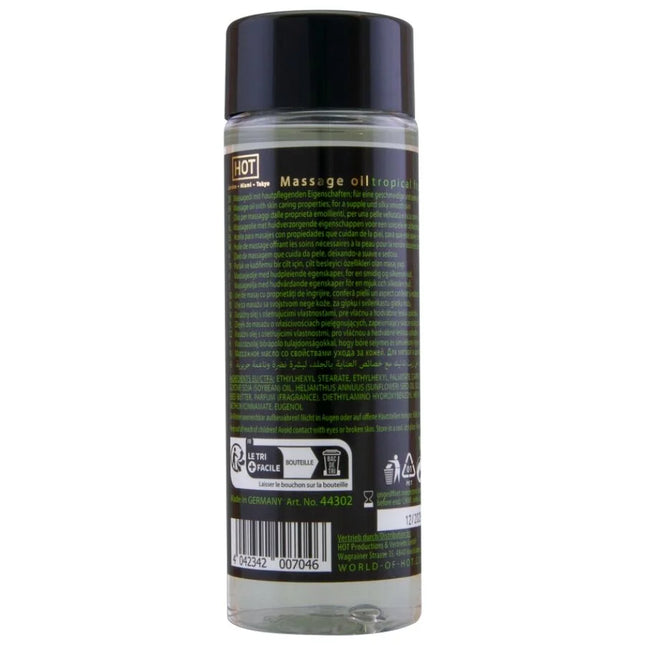 Klare glasflasche mit schwarzem verschluss und etikett enthält tropisches massageöl hot - massageöl tropische früchte 100 ml