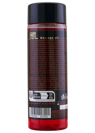 Eine klare kunststoffflasche mit schwarzem deckel, gefüllt mit rotem warmem massageöl hot von london miami tokyo 100 ml