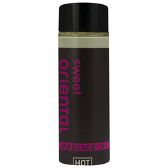 Ein schwarzes, glänzendes fläschchen mit pinkem sweet oriental massageöl text für orientalisches Massageöl süß 100 ml