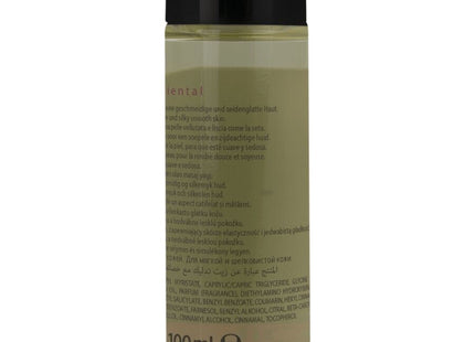 Eine klare glasflasche mit schwarzem deckel enthält olivgrünes hot orientalisches massageöl süß 100 ml