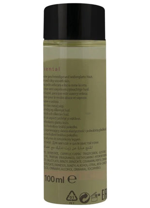 Eine klare glasflasche mit schwarzem deckel enthält olivgrünes hot orientalisches massageöl süß 100 ml