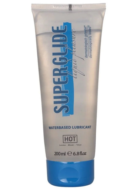 Ein transparenter silberner schlauch mit blauem deckel und schriftzug superglue als wasserbasiertes gleitmittel hot variant
