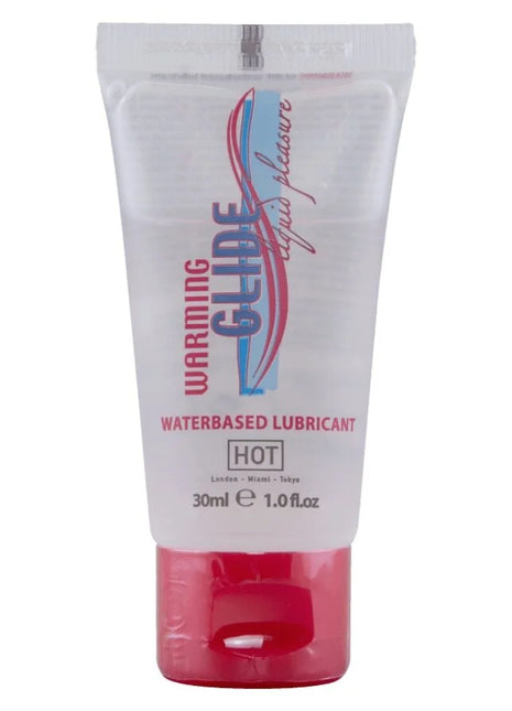 Transparenter kunststofftube mit rotem verschluss und blauem pinkem weißem branding für warming glide wasserbasiertes gleitmittel hot 30 ml