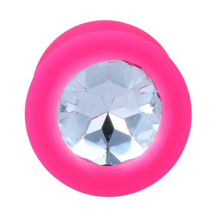 Ein lebendiger pinkfarbener silikon-analplug intense shelki m mit klarem facettenkristall in der mitte