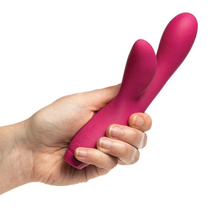 Ein lebhafter magentafarbener silikonschwinger mit zwei köpfen und ergonomischem griff von je joue hera rabbit vibrator