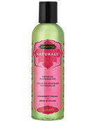 Ein durchscheinendes grünes fläschchen des kama sutra natürlichen massageöls erdbeertume 59 ml mit schwarzem verschluss und rosa blumenetikett