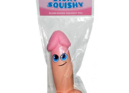 KHEPER GAMES - pinke dicky squishy spielzeug mit blauen Augen und Lächeln in klarem Plastik verpackt
