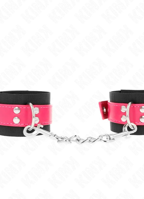KINK - NYLON HANDGELENKFESSELN SCHWARZ MIT KUNSTLEDERGÜRTEL HIMBEERROSA VERSTELLBAR 19-29 CM X 5,1 CM