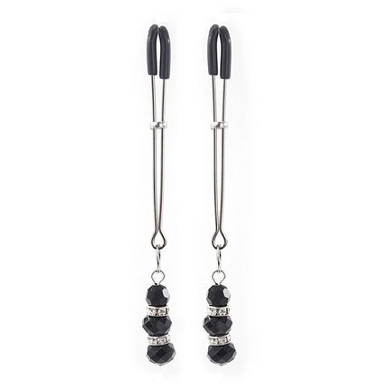 A pair of black and silver ohmama fetish nipple clamps with faceted black beads and crystal accents