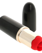 Ohmama lippenstift mit vibrierender zunge in schwarz mit goldband und roter silikonspitze gelegen in schlankem zylinder