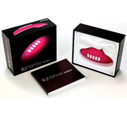 Vibrant pink ohmibod lightshow-lichtstimulator mit fernbedienung und fünf weißen tasten seitlich