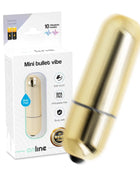 Sleek goldene mini vibrationskugel in zylinderform mit glatter metallischer oberfläche und schwarzer spitze