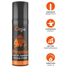 Schwarze zylindrische dose orgie piranha power creme für ihn 15 ml mit orangefarbenem fischgraphic und inhaltsstoffen