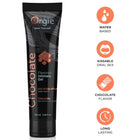 Schwarze tube orgie schokoladen-schmiergel mit orangem text und schokoladenmotiv zur intimen anwendung 100 ml