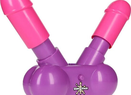 Lila und pinkes plastikspielzeug cumo face mit zwei zylindrischen enden aus der play wiv me cum face party spiel serie