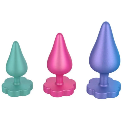 Drei bunte romp luster anal butt plugs in teal, pink und lila mit blumenförmiger basis für verrutschen verhindert