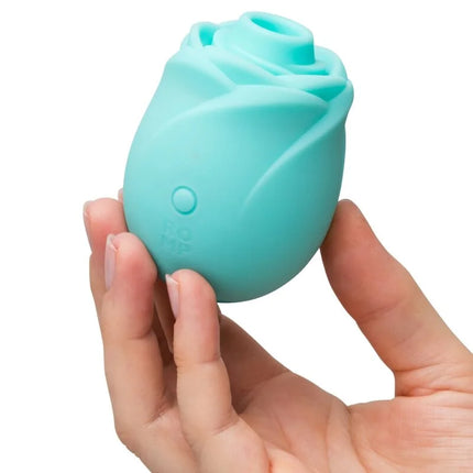 Teal silikon rose glow druckwellenstimulator in leuchtender rosenform mit rundem design und seitlichem knopf