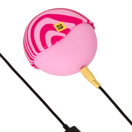 Kompakter runder auflegevibrator romp spin mit pink-magenta gestreiftem usb-ladekabel und äußerer stimulation