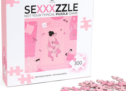 Rosa puzzlekasten für das sexxxzzle spiel von secret play mit spielerischer illustration zweier figuren in intimer szene