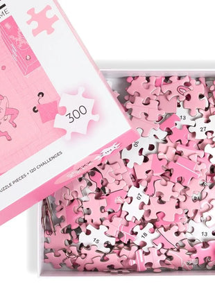 Pink puzzle pieces with white numbers scattered in a box beside matching pink and white lid secret play puzzlespiel sexxxzzle