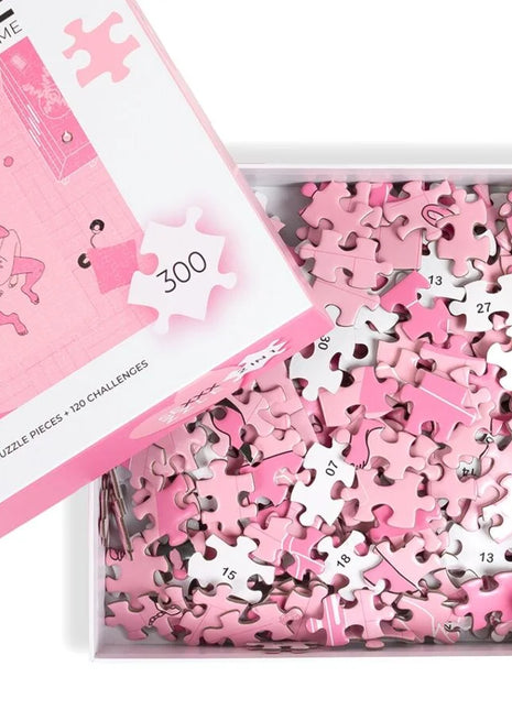 Pink puzzle pieces with white numbers scattered in a box beside matching pink and white lid secret play puzzlespiel sexxxzzle