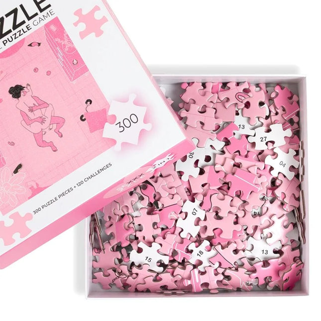 Pink puzzle pieces with white numbers scattered in a box beside matching pink and white lid secret play puzzlespiel sexxxzzle