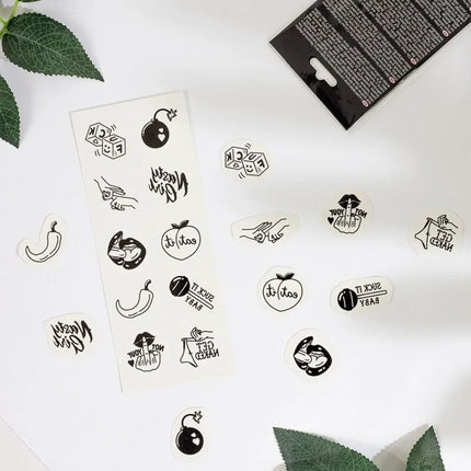 Ein set mit 10 schwarz-weißen temporären tattoos aus der spicy kollektion mit verspielten designs wie würfeln und bombs