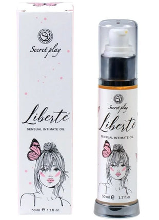 Weiße zylinderflasche mit schwarzem pumpenspender und silberner basis für liberté sensual intimate oil von secret play