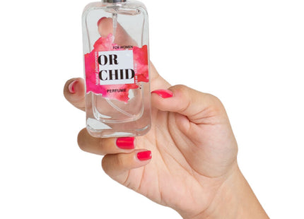 Eine klare glasparfümflasche mit silberner sprühdüse und pinkem blumenetikett or chid secretplay orchidée natürliche pheromon parfumspray 50 ml