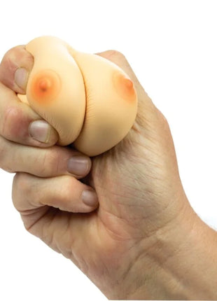 Beige silikon stressball in brustform mit orangenem nippel design von spencer und fleetwood zur stressreduktion