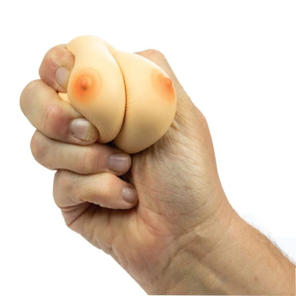 Beige silikon stressball in brustform mit orangenem nippel design von spencer und fleetwood zur stressreduktion