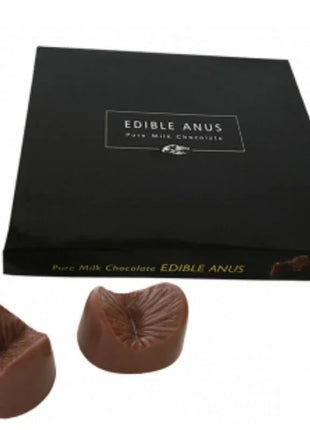 Ein paar braune melkuchenschokoladen in anusform in einer schwarzen schachtel von spencer und fleetwood chocolate