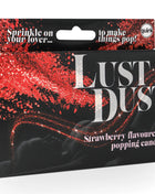 Rote glitzernde erdbeergeschmack essbares pulver in schwarzer box mit silbernem quirK logo von spencer & fleetwood