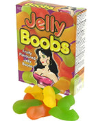 Bunte box kaubonbons in form von brüsten mit cartoonillustration und fruchtigen jelly bonbons vorne liegend