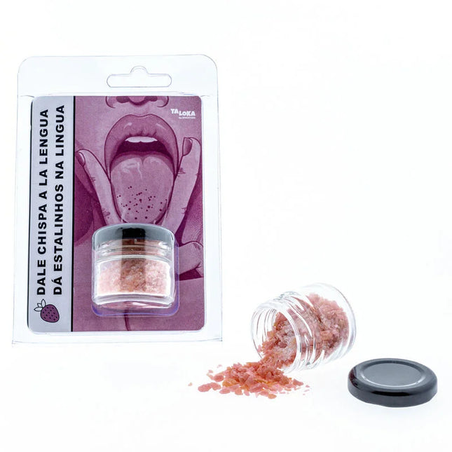 Ein klarer glasbehälter mit schwarzem deckel, der rosa-rote körnige erdbeer-zauberküsse von taloka enthält