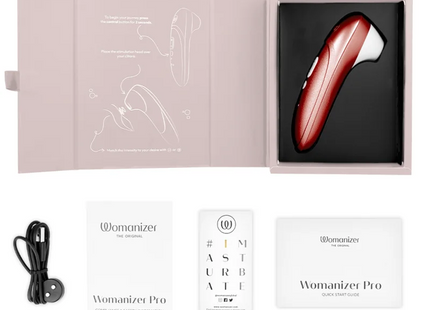 Eine glänzende rote und weiße womanizer pro vibrierende klitorisstimulator mit ergonomischem design