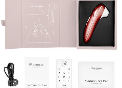 Eine glänzende rote und weiße womanizer pro vibrierende klitorisstimulator mit ergonomischem design